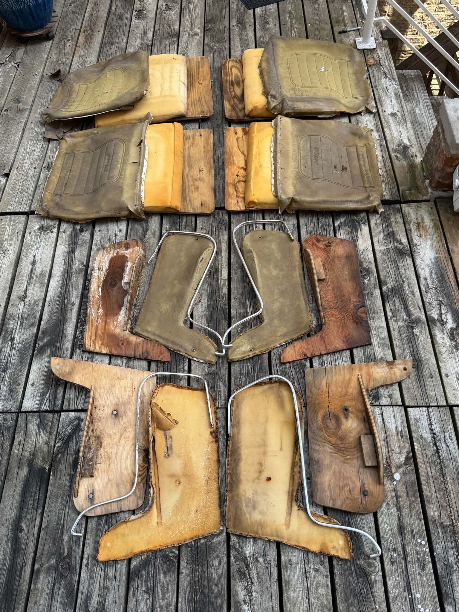 Original upholstery and wood substrates laid out for rebuild