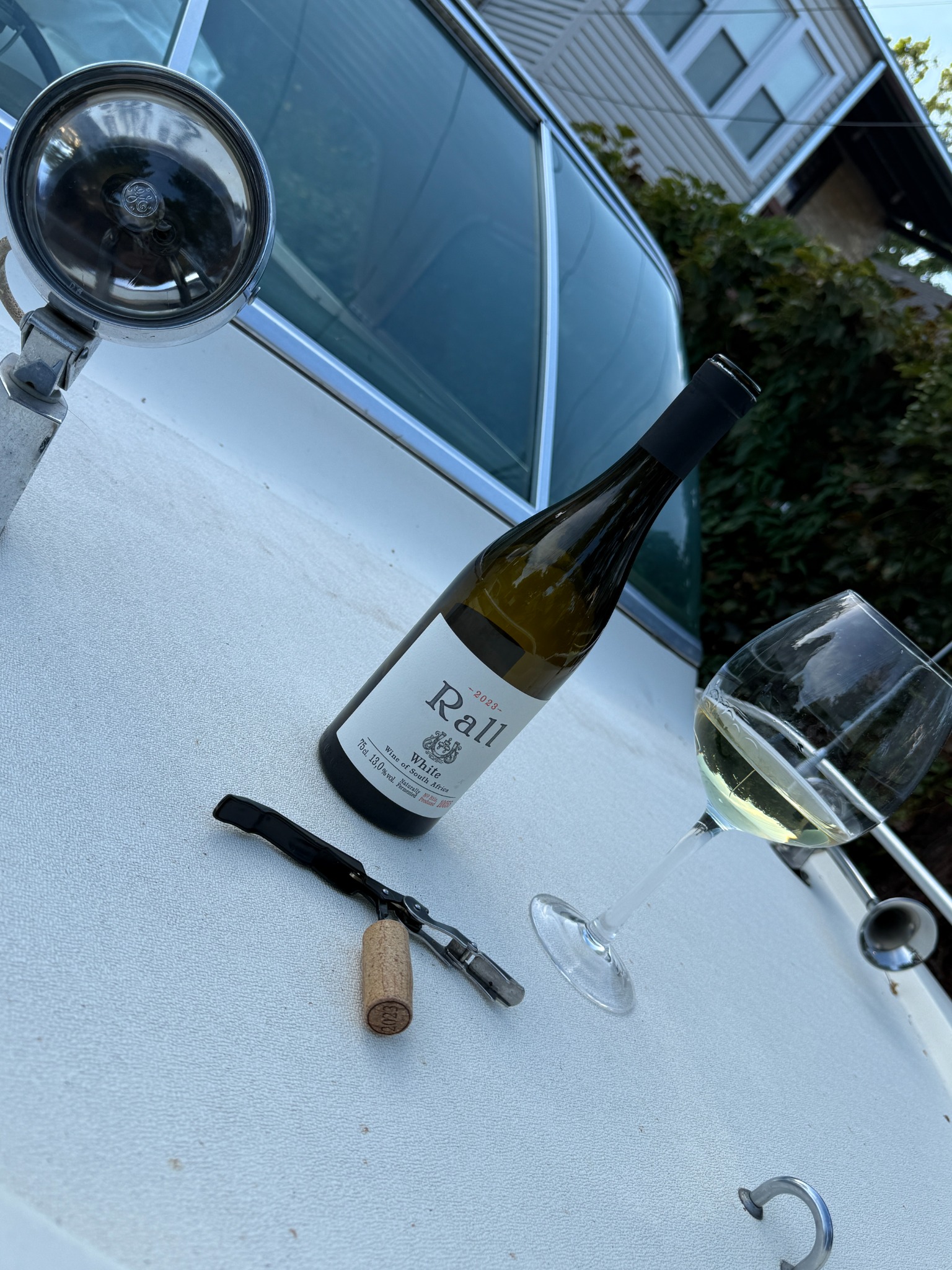 Bottle of Rall White and a wine glass staged aboard Decanter during restoration