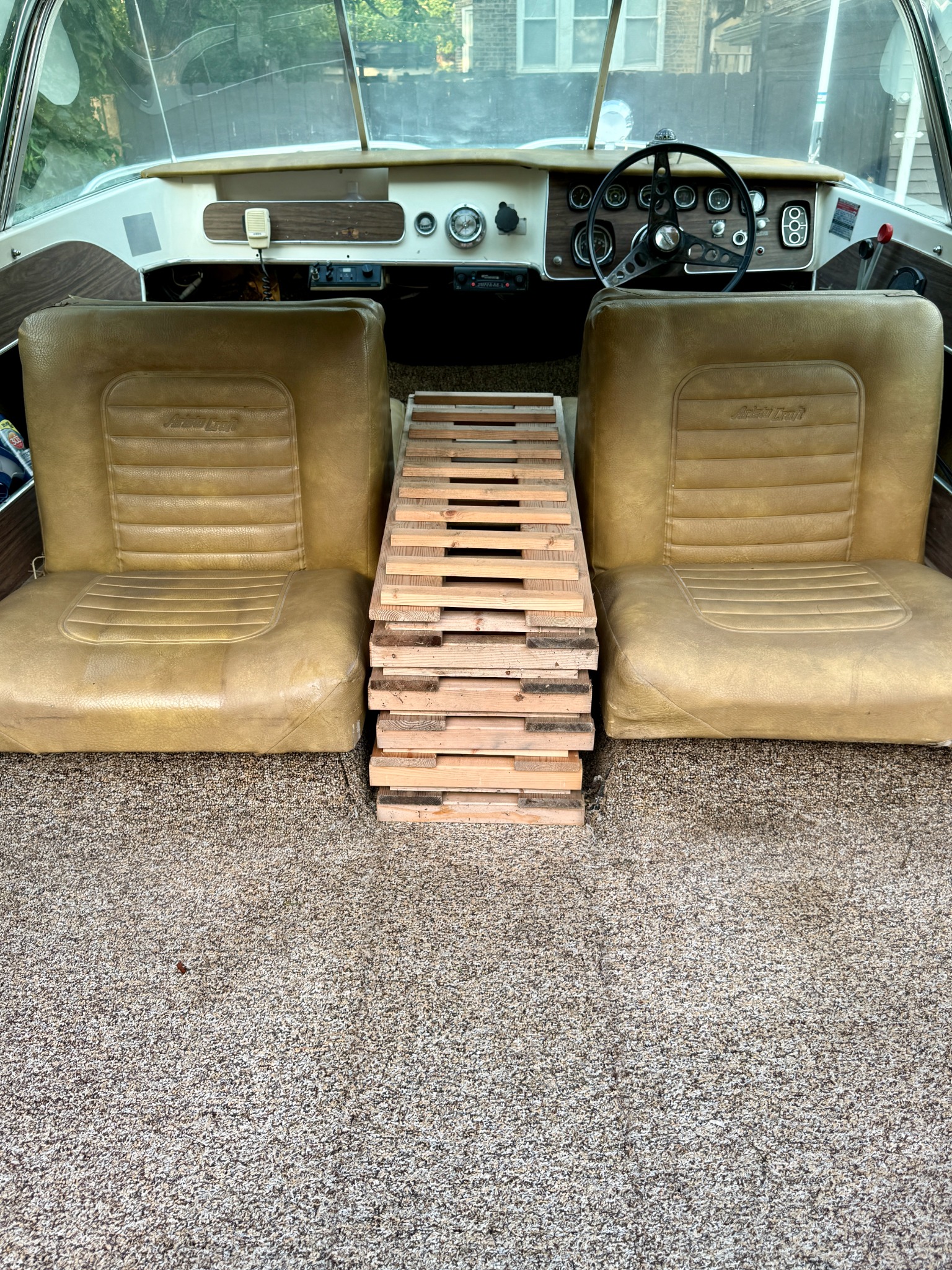 Salvaged wooden wine racks placed between the original seats